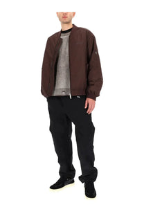 Represent men’s bomber jacket in smart brown leather with subtle chest logo and zipper details