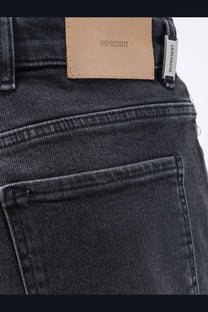 Dark-wash denim represent men’s boot cut jeans black with tan leather brand patch and silver tag embroidered represent