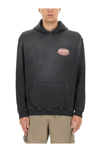 Black oversized represent men’s british luxury sweatshirt with faded pink oval logo and ribbed cuffs and hem