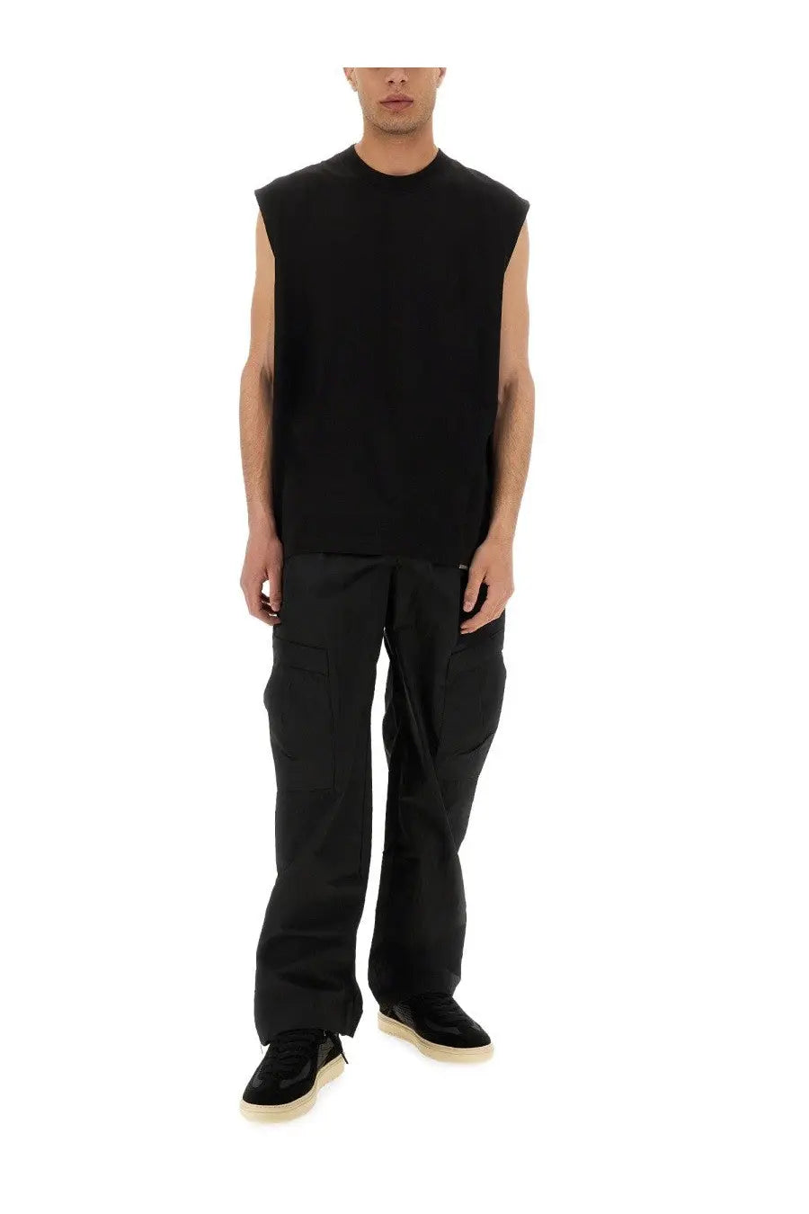 Black sleeveless knit top with crew neckline and relaxed fit paired with represent men’s cargo tech pants black