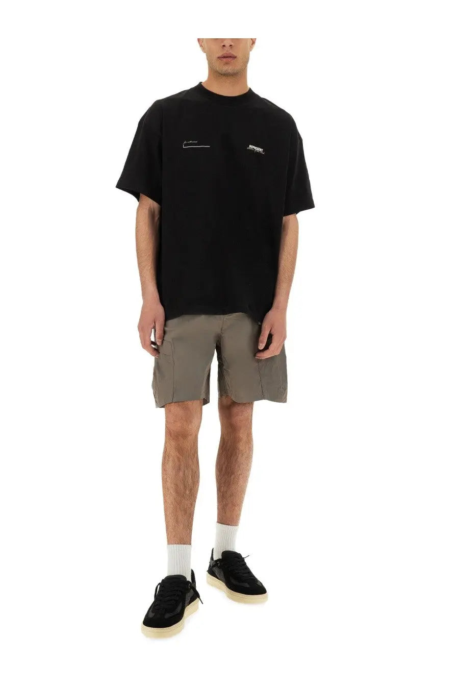 Black oversized t-shirt with subtle white embroidered logos on the chest paired with grey represent men’s cargo tech shorts