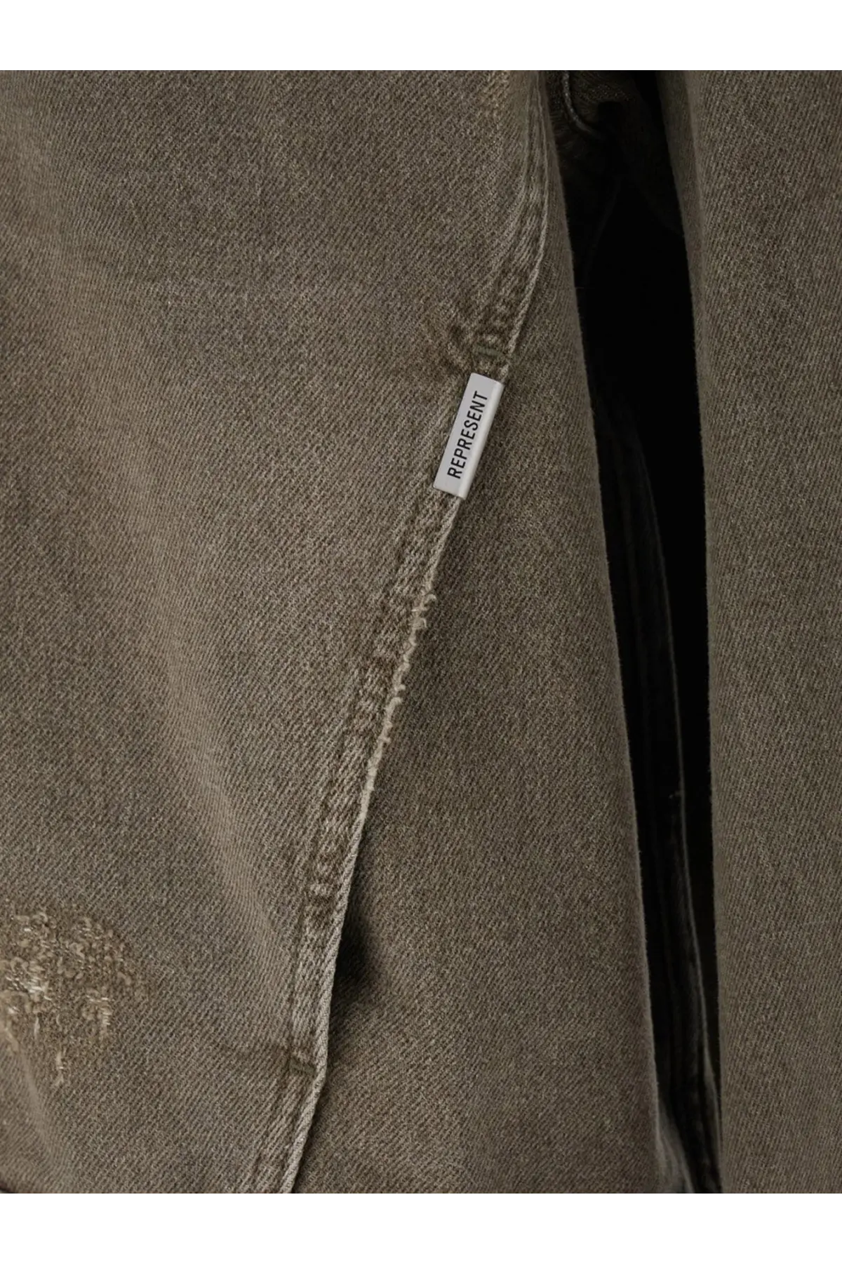 Represent men’s denim jacket green in faded olive with distressed texture frayed stitching and white label on the seam
