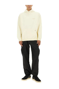 Cream-colored cotton Represent men’s hoodie in beige with subtle embroidered logo on the chest front