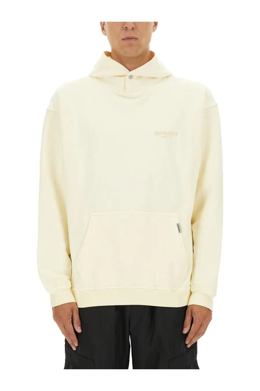 Cream-colored Represent men’s hoodie beige with hood, subtle embroidered logo, and front pocket with small zipper pull