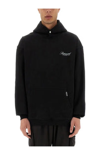 Black represent men’s hoodie with white embroidered logo on chest and small silver tag near front pocket