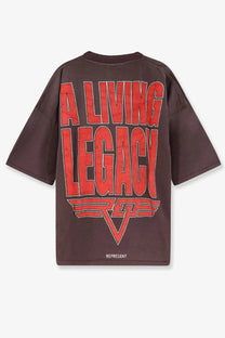 Dark brown oversized t-shirt with bold red a living legacy graphic and stylized logo in organic cotton hemp blend