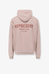 Back of a soft blush pink cotton hoodie with bold muted red represent owners club graphic for men by represent