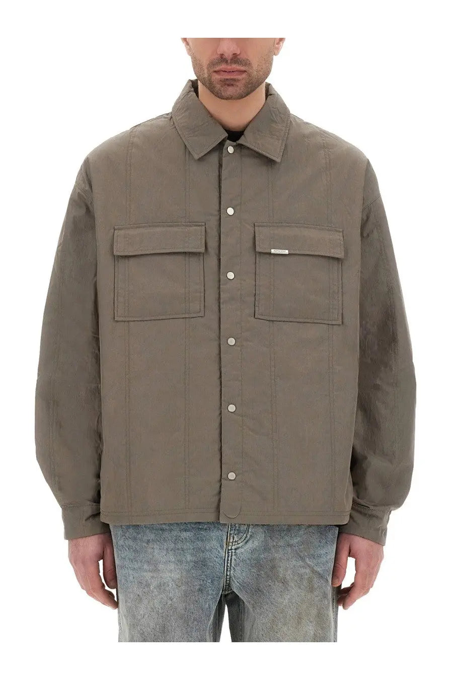 Represent men’s quilted overshirt green is a muted olive green quilted button-up jacket with flap pockets and a brand tag