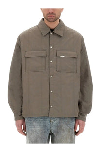 Represent men’s quilted overshirt green is a muted olive green quilted button-up jacket with flap pockets and a brand tag
