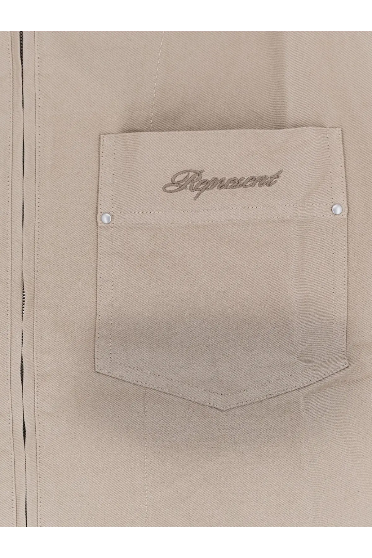 Beige denim jacket pocket with represent embroidered in silver thread and white snap buttons on represent men’s ramona cotton shirt green