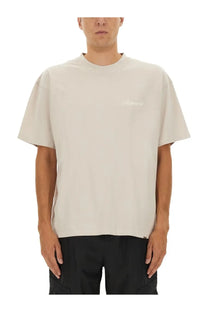 Represent men’s beige short-sleeved crew neck t-shirt with subtle white embroidered logo on left chest