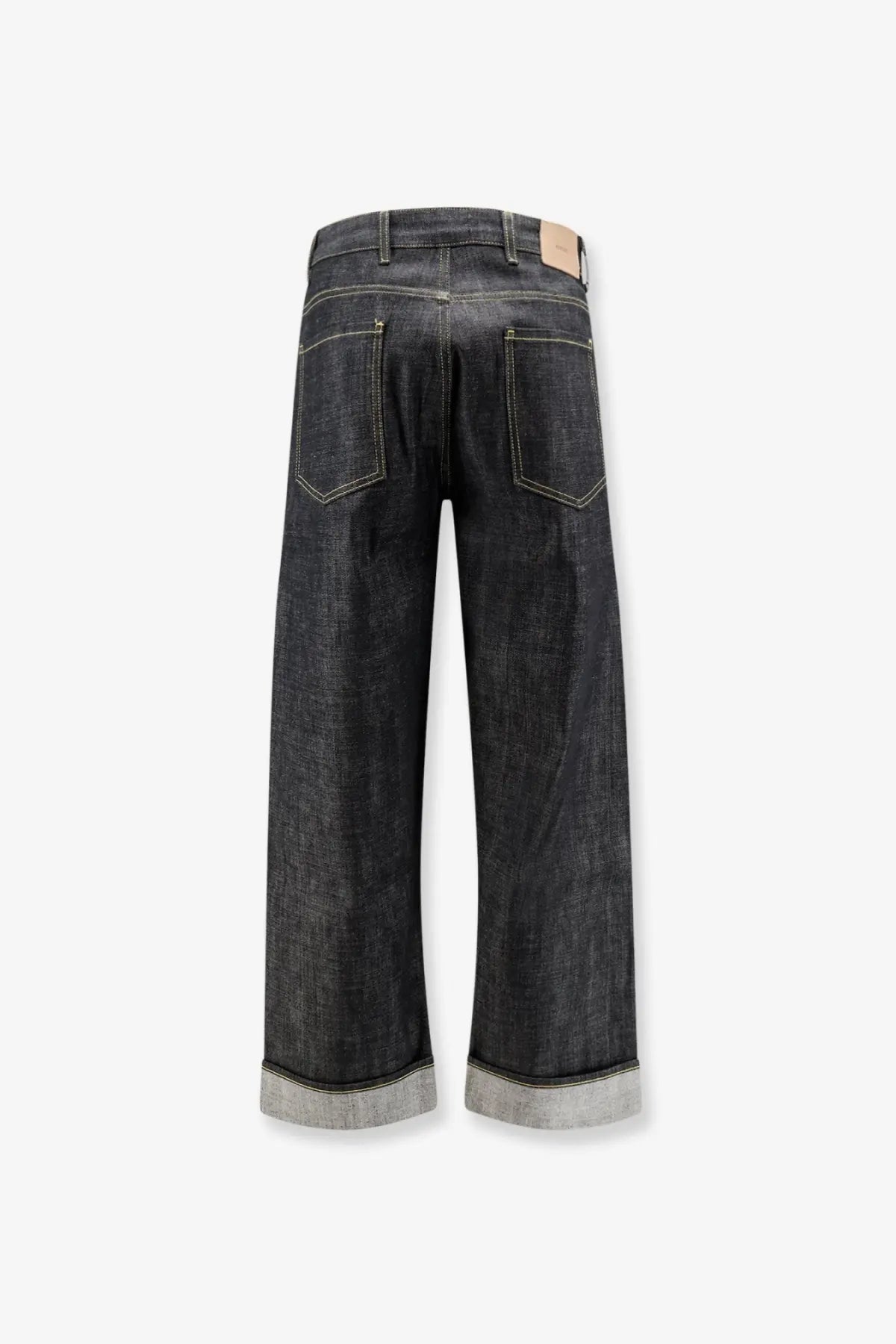 Dark-wash wide-leg denim jeans with rolled cuffs contrasting stitching and beige leather brand tag at waistband