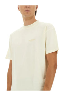 Cream-colored minimalist represent men’s beige crewneck t-shirt with subtle embroidered logo on left chest