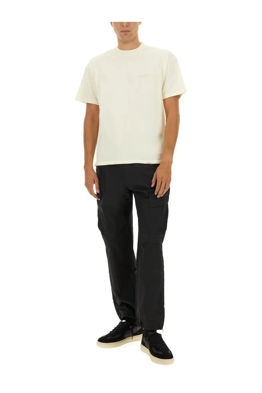 Cream-colored short-sleeved crew neck represent men’s shirt beige with subtle embroidered logo on left chest