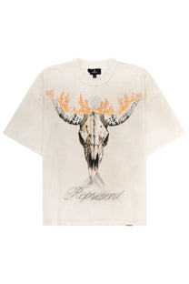 Off-white short-sleeved cotton shirt with black and orange flaming bull skull graphic and represent text below