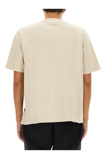 Represent men’s beige oversized short-sleeved shirt with relaxed fit and subtle side seam detailing