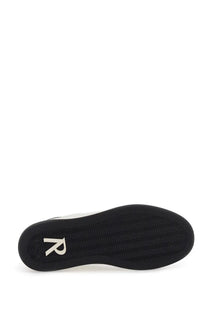 Back view of represent men’s sneaker initial black showing black rubber sole with white r logo on the heel