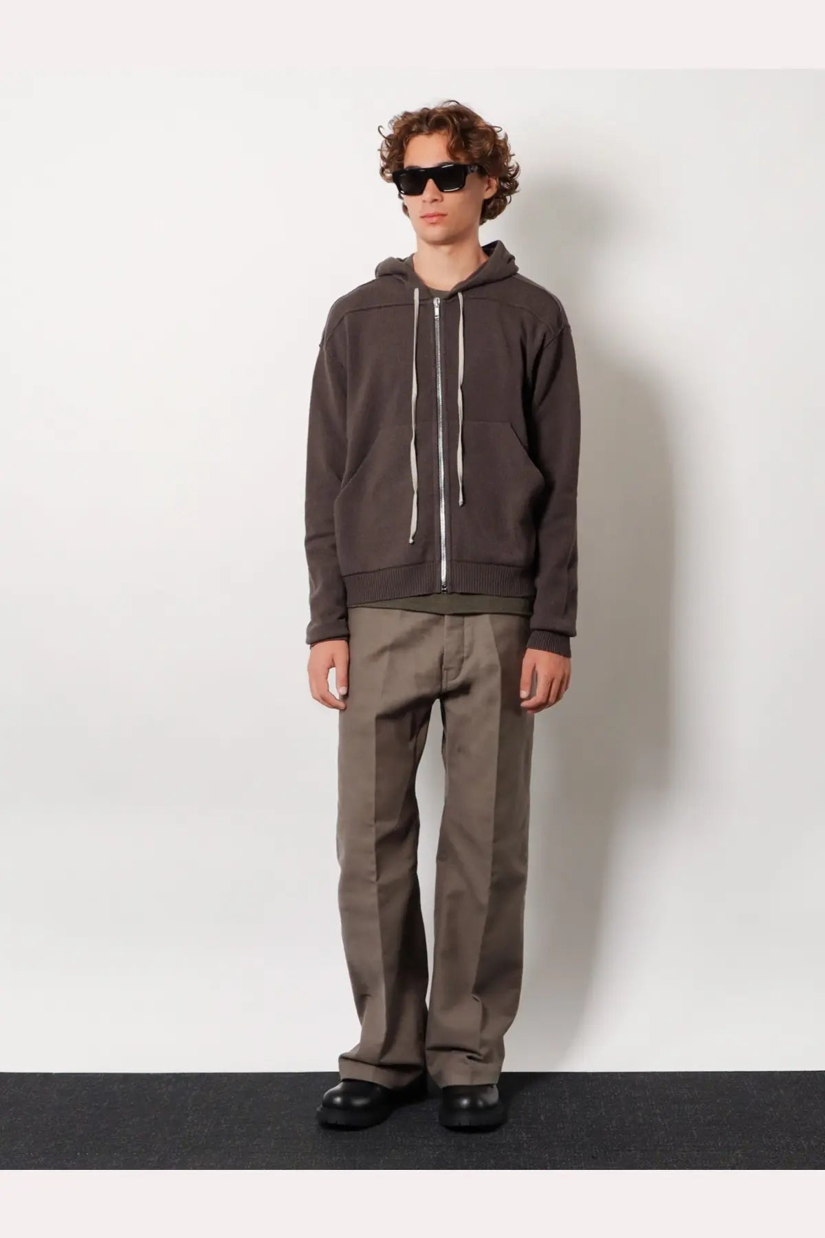 Rick owens men’s basic ls viscose blend shirt green paired with a dark gray zip-up hoodie with white drawstrings and ribbed hem
