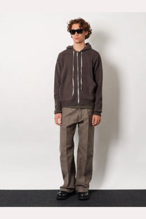 Rick owens men’s basic ls viscose blend shirt green paired with a dark gray zip-up hoodie with white drawstrings and ribbed hem