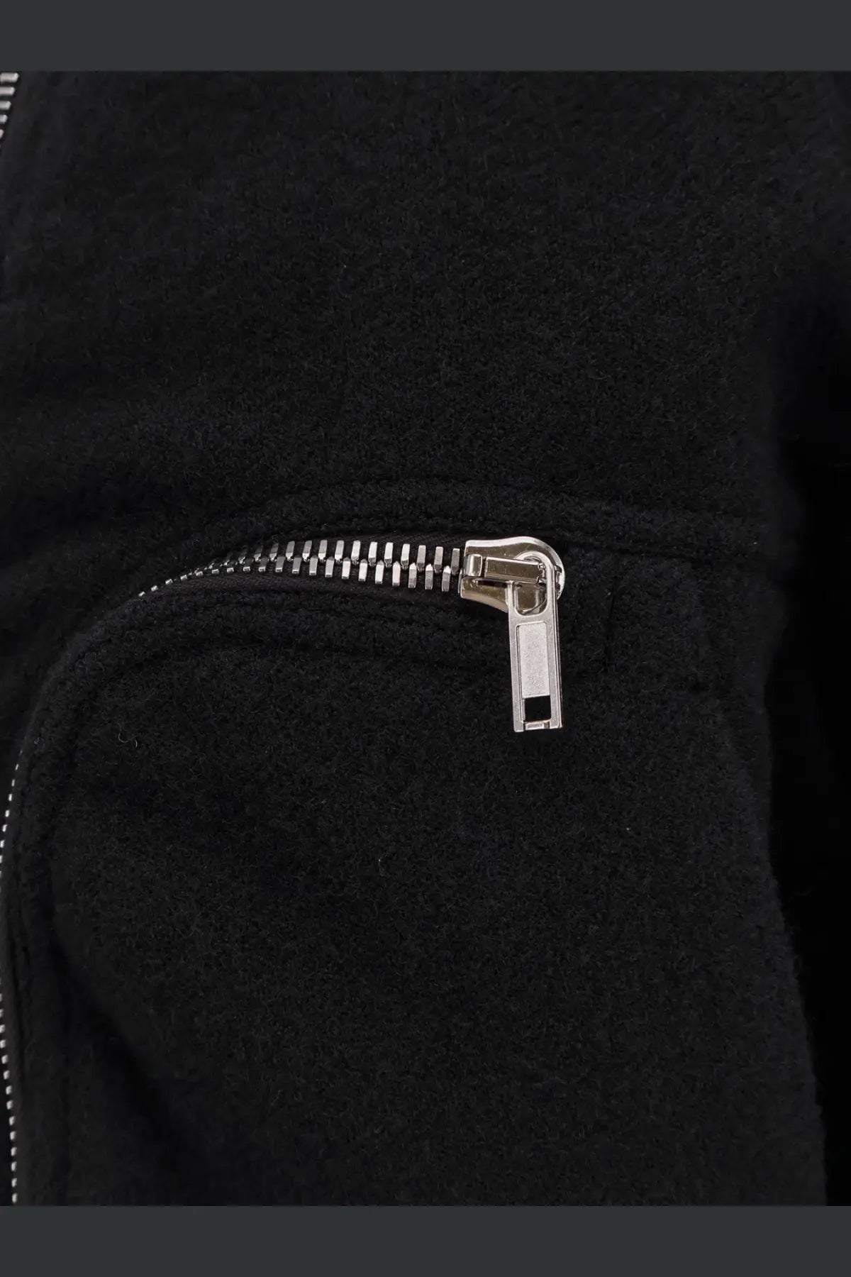 A sleek silver zipper with a metallic pull tab on the black virgin wool rick owens men’s bauhaus flight bomber jacket