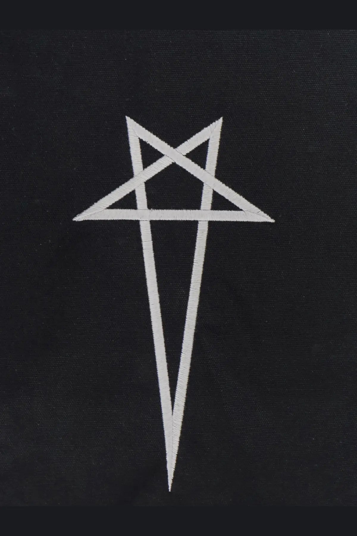 White embroidered pentagram patch on black canvas fabric of rick owens mens handbag
