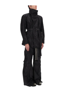 Rick Owens men’s black cargo belas pants paired with a black high-necked trench coat with belted waist and long sleeves