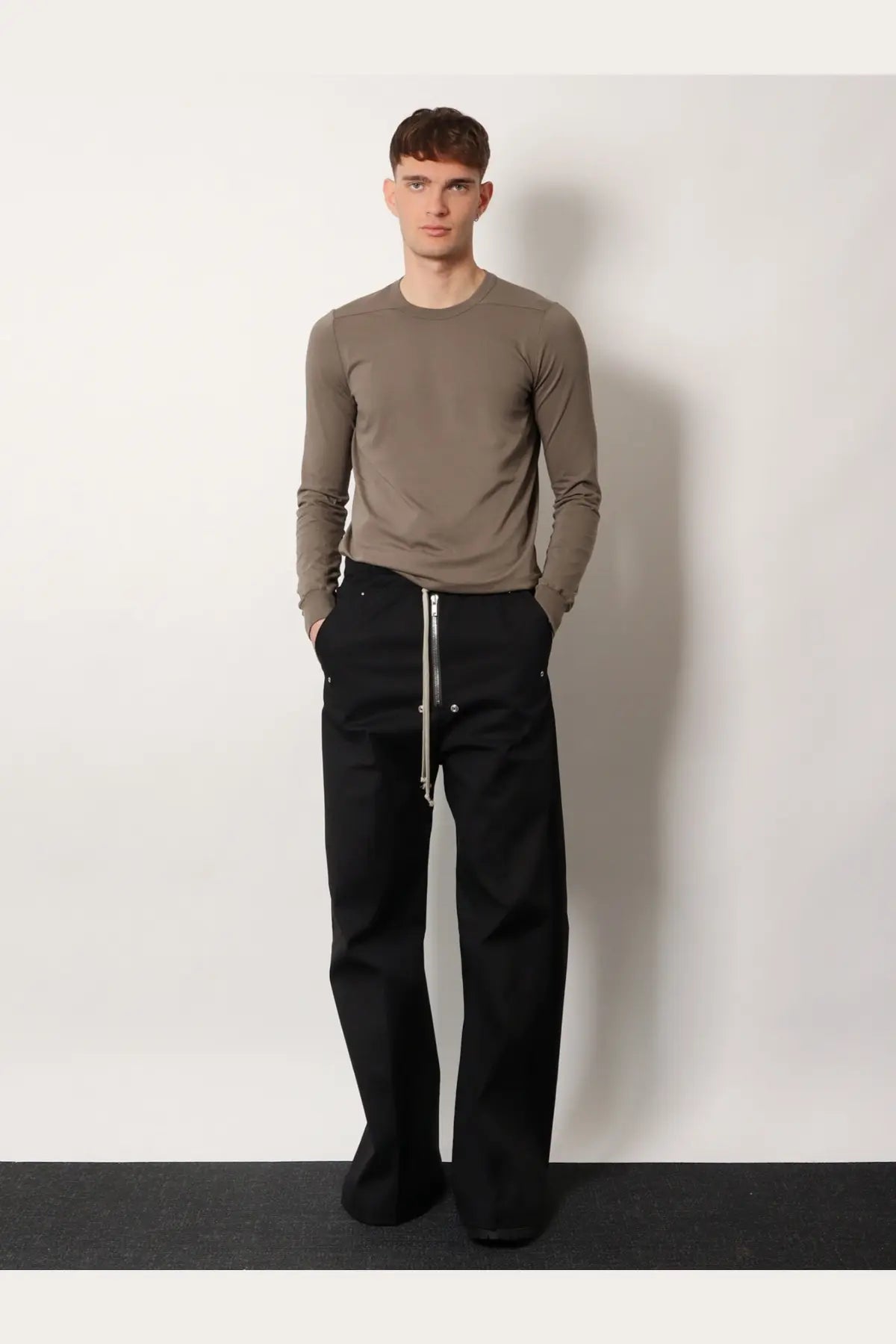 Black wide-leg cotton trousers with silver front zipper and metallic buttons paired with rick owens grey shirt