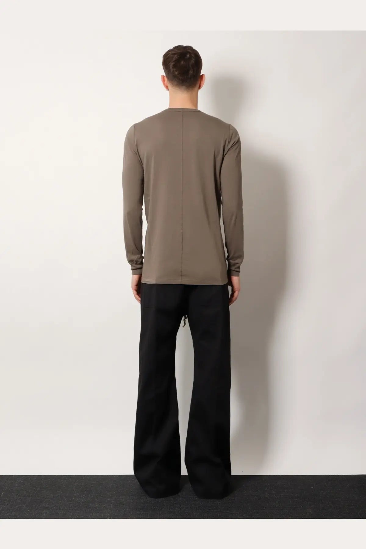 Back view of a minimalist rick owens men’s cotton shirt grey in taupe with a subtle vertical seam down the back