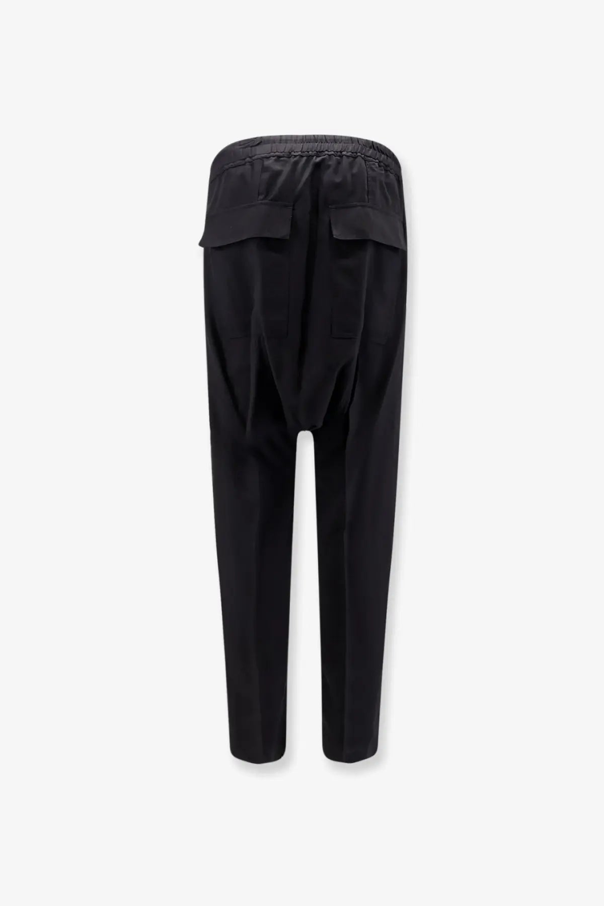 Back view of black rick owens men’s tapered virgin wool trousers with elastic waistband and two flap pockets