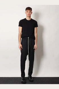 Rick Owens men’s black tapered drawstring trousers in certified virgin wool with white zipper pull and side seam detailing