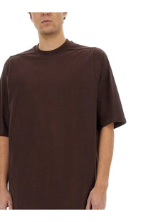 Rick Owens men’s jumbo shirt in brown features a dark brown oversized short-sleeved relaxed fit with subtle seam detailing
