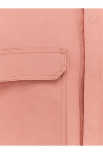 A soft pink fabric pocket with neat stitching on a rick owens men’s organic cotton shirt orange