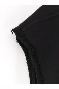 Black fabric close-up of the frayed textured edge of rick owens men’s sleeveless organic cotton sweatshirt black