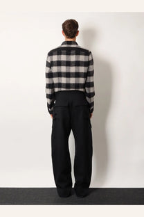 Black and gray plaid woolen sweater with classic check pattern paired with rick owens men’s stefan cargo virgin wool trousers black