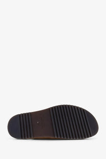 Dark brown rubber sole with ribbed texture and clarks branding on rick owens men’s suede brown sandals back side