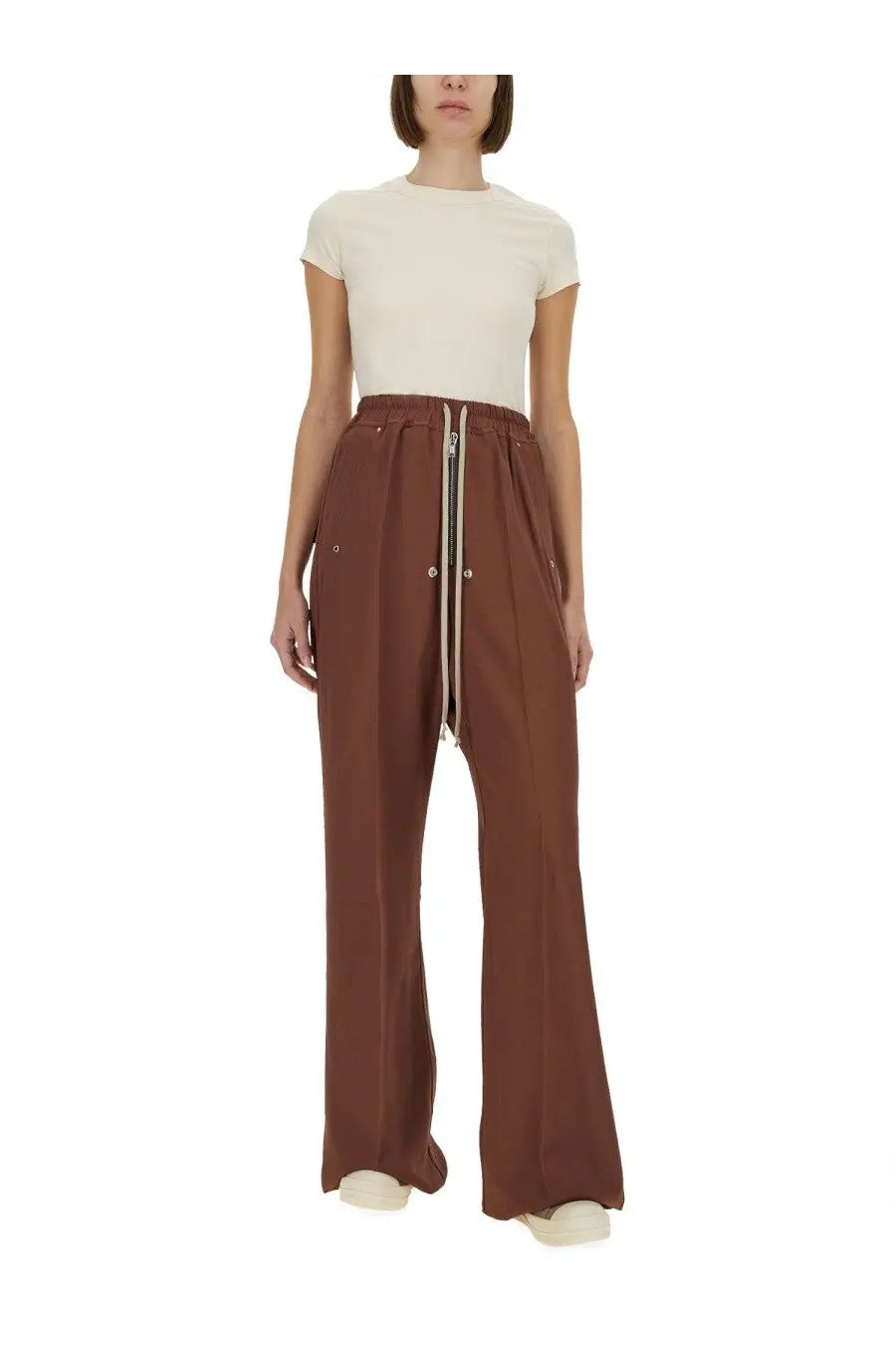 Brown wide-leg trousers with central zipper side pockets and elastic waistband paired with rick owens white cropped shirt