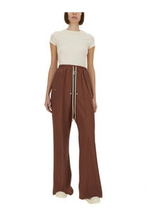 Brown wide-leg trousers with central zipper side pockets and elastic waistband paired with rick owens white cropped shirt