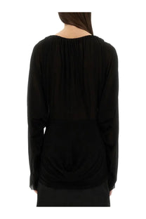 Back view of rick owens women’s black draped top with gathered ruched back and soft flowing fabric