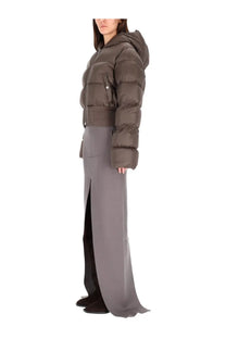 A dark olive green quilted puffer jacket with hood and front zipper paired with a rick owens grey long skirt