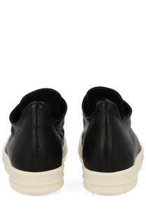 Rick Owens women’s low sneaks black leather slip-on sneakers with thick off-white rubber sole shown from the back