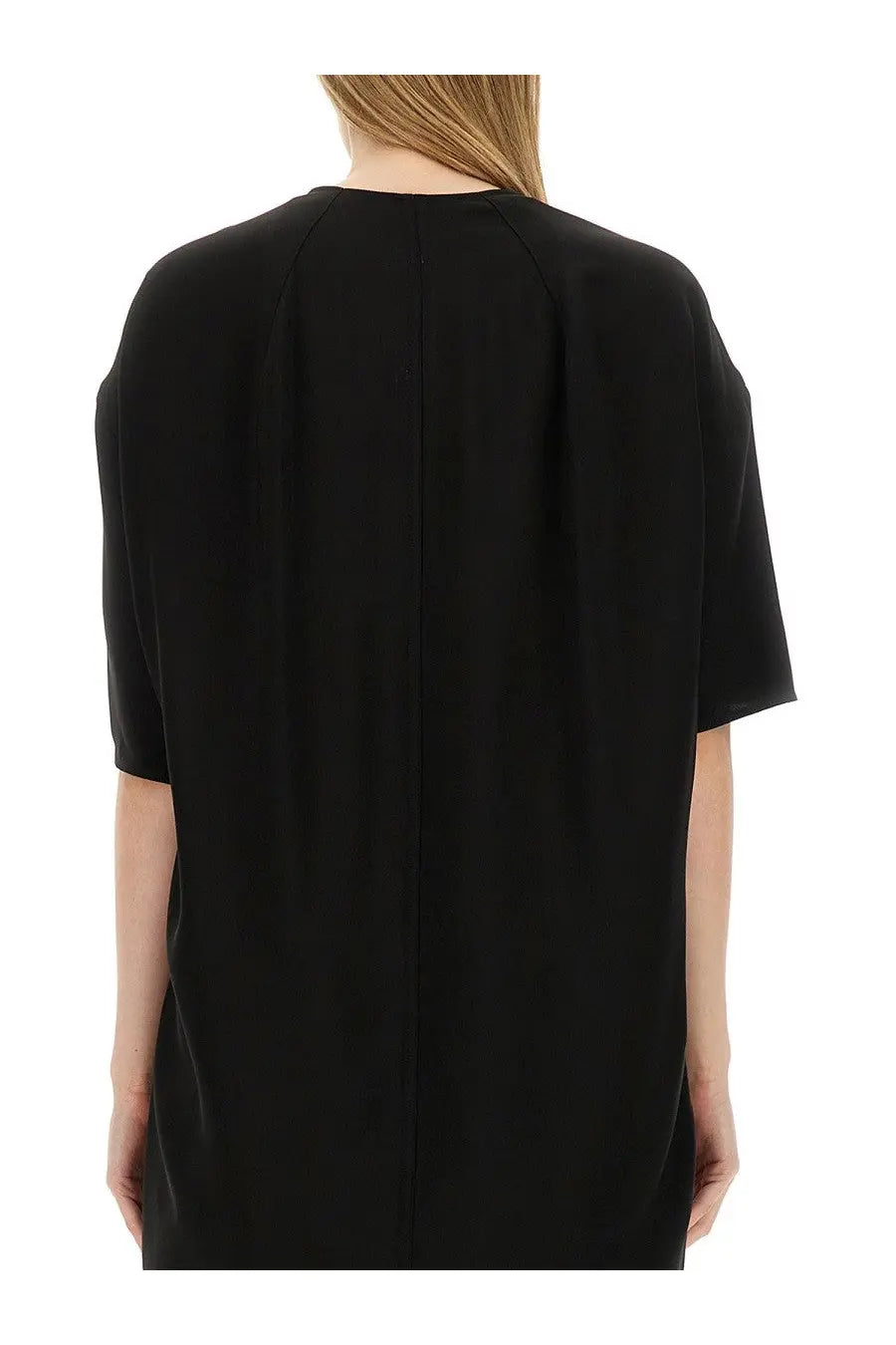 Black minimalist dress by rick owens with short sleeves and straight back seam shown from the back side