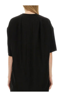 Black minimalist dress by rick owens with short sleeves and straight back seam shown from the back side