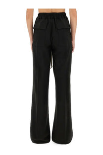 Back view of rick owens women’s black wide-leg pants with elastic waistband and large flap pockets