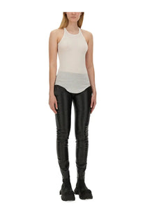 Black glossy faux leather leggings paired with rick owens women’s white tank top for a bold modern look