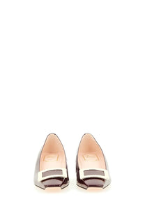 Black patent leather ballet flats with white rectangular buckle at toe from roger vivier women’s belle vivier pumps red collection