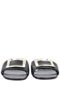 Roger Vivier women’s black leather slide sandals with a gold-tone rectangular buckle front detail