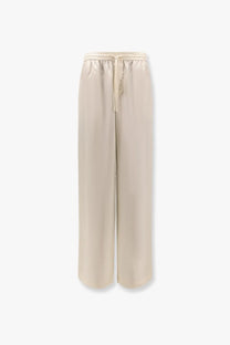 Beige wide-leg Rohe women’s jogger silk trousers with satin finish and elastic waistband in white color