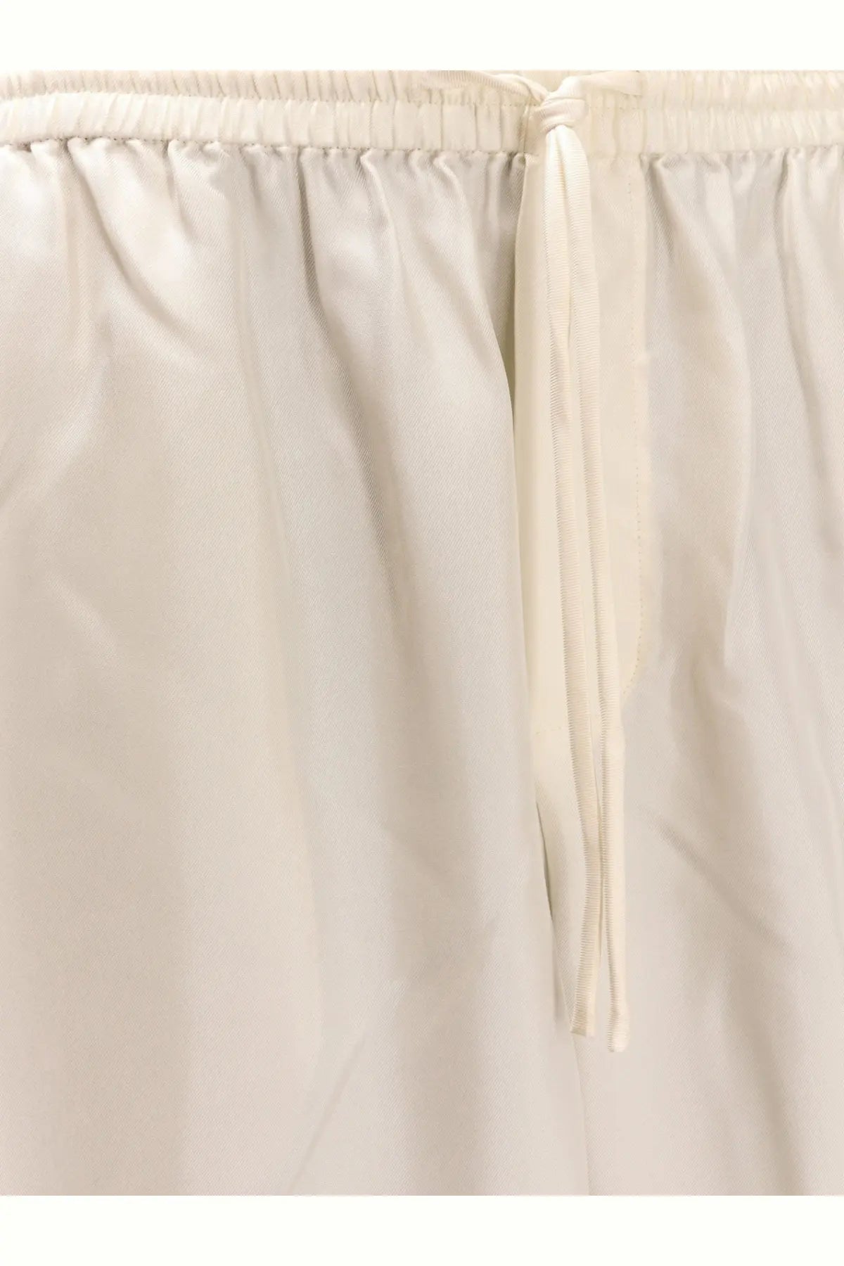 Rohe women’s jogger silk trousers in cream color featuring lightweight fabric and elastic waistband with matching drawstring
