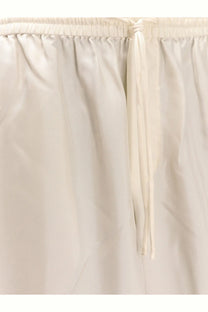 Rohe women’s jogger silk trousers in cream color featuring lightweight fabric and elastic waistband with matching drawstring