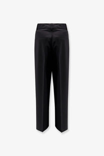 Black wool blend rohe women’s midwaist trousers with a sleek straight-leg cut and subtle back pleats shown from the back